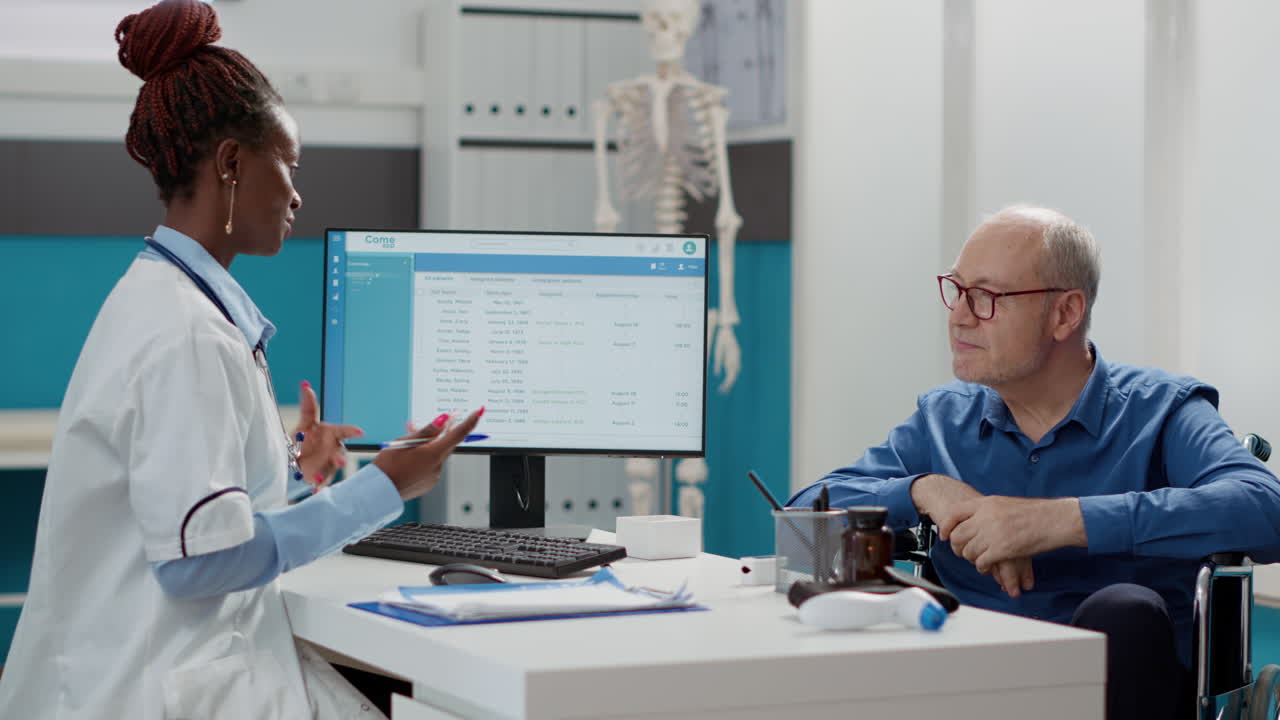 Doctor Consulting with Senior Patient in Wheelchair