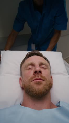 patient being moved by a medical professional in a hospital hallway