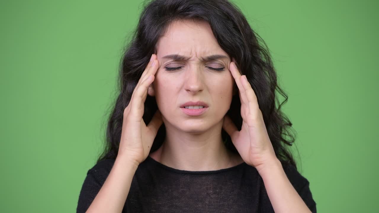 Young beautiful woman having headache