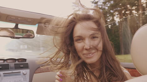 happy woman driving convertible