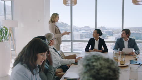 beautiful-business-woman-team-leader-discussing-creative-ideas-with-shareholders-briefing-colleagues-sharing-company-development-strategy-in-office-boardroom-meeting-4k