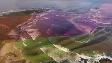 composición digital de agitar la bandera de alemania contra la vista aérea de las olas del mar