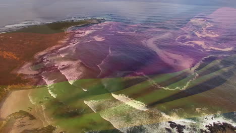 digital composition of waving germany flag against aerial view of the sea waves