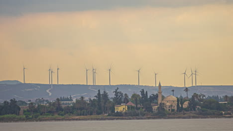 wind power generators, windmills, on a hill next a village