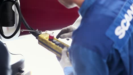 mechanic working on a piece of industrial machinery.