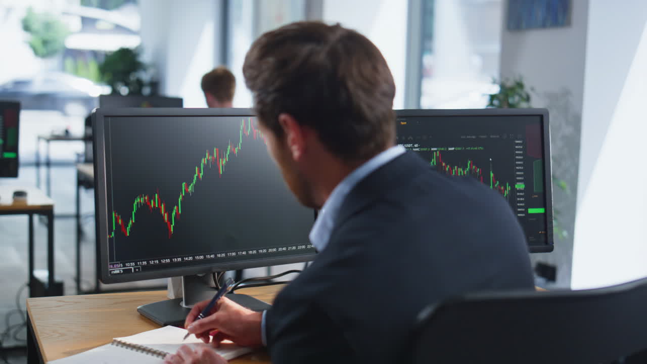 Forex trader working computer analyzing graphs at company office space closeup