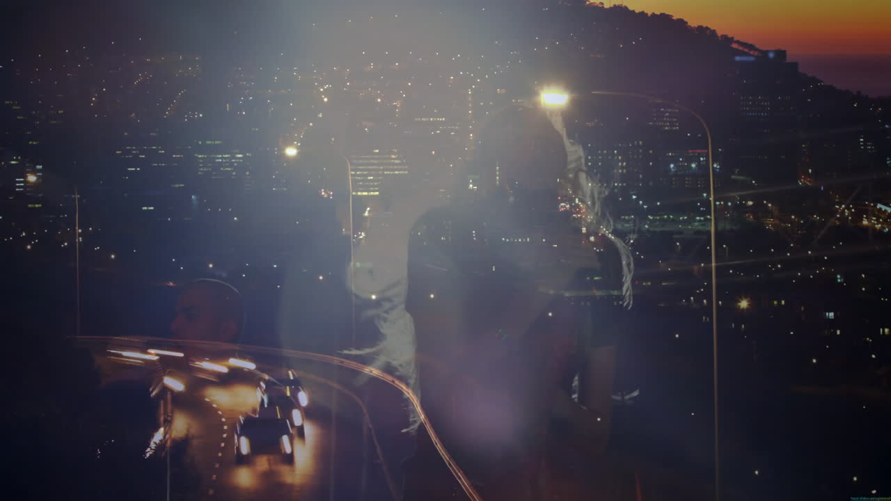 music duo singing in dim-lit studio at night, showing vintage mic against cityscape reflections