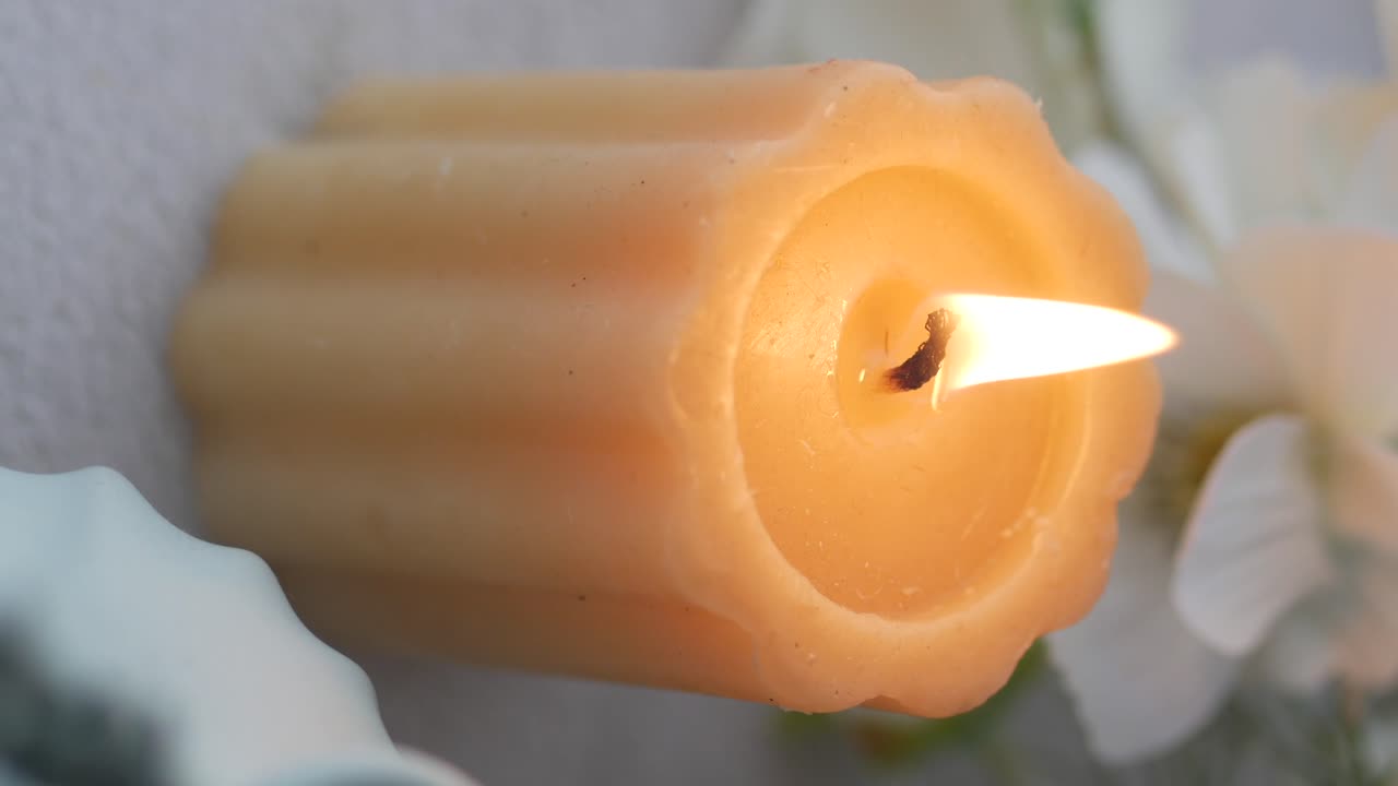 Close-up of a Lit Candle with a Warm Flame