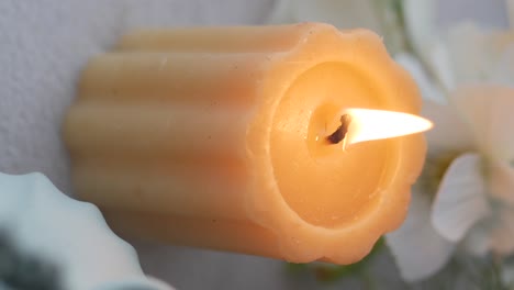 close-up of a lit candle with a warm flame