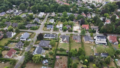 beautiful jib up of a wealthy neighborhood in bruges, belgium. the area is surrounded by green trees and gardens and new house is being constructed