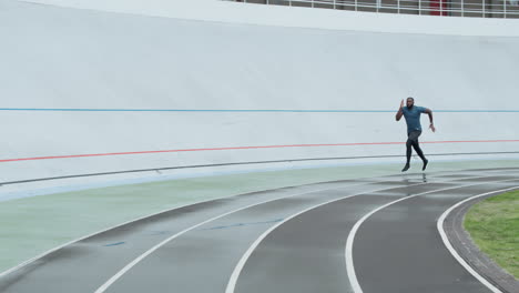 man in sportswear jogging on racetrack