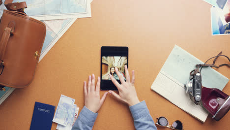 top view woman traveler using digital tablet touchscreen planning holiday at vintage desk from above - red epic dragon