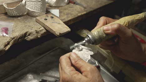 jeweler at work in jewelry. desktop for craft jewelry making with professional tools. close up view of tools.