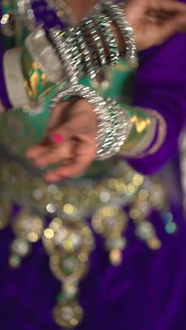 vertical video close up on hands of female kathak dancer performing dance wearing traditional indian dress 1