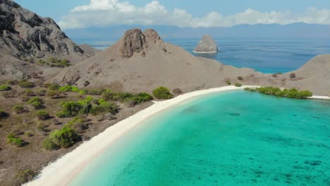 Scenic-View-Of-Pink-Beach-With-Rugged-Hills-On-The-Komodo-Islands-In-Indonesia