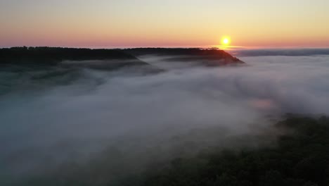 sunrise over misty mountains