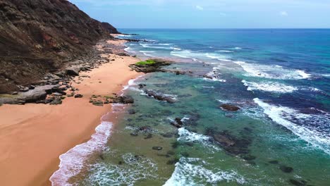 aerial view of rugged coast , blue waves, 4k