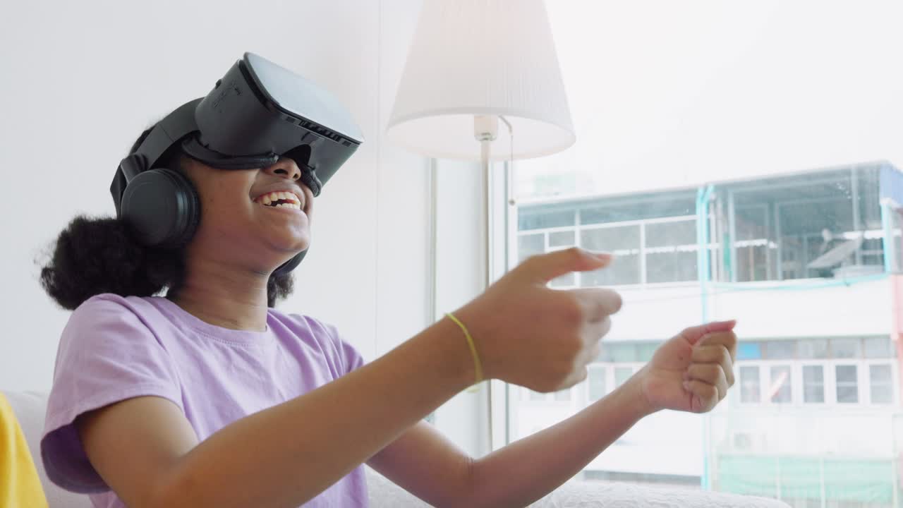 african american Girls play games through VR glasses. Young girl sits in virtual reality glasses and flips through social networks. learning in the virtual world