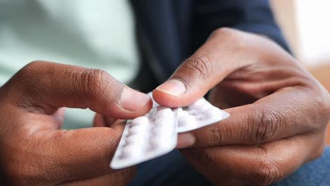 person holding a pack of pills