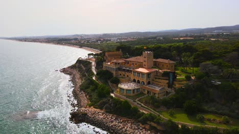 aerial 4k drone footage of a georgeous beach villa next to ermita de la mare de déu de ber?