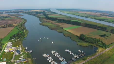 Aerial-panoramic-shot-of-drone-flying-around-marina-with-yachts-in-Blotnik,-Pomeranian,-Poland