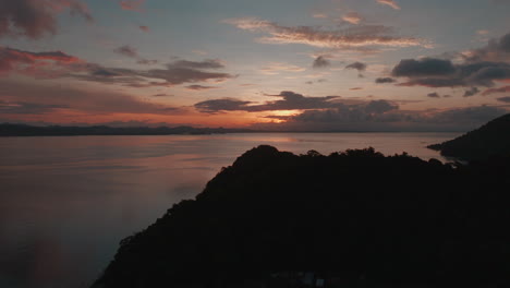Koh-Chang,-Thailand,-as-a-drone-soars-gracefully-over-a-lush-jungle-canopy-during-the-enchanting-sunset-hours