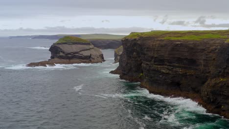 aerial pal of kilkee dark face cliffs and islet in county clare