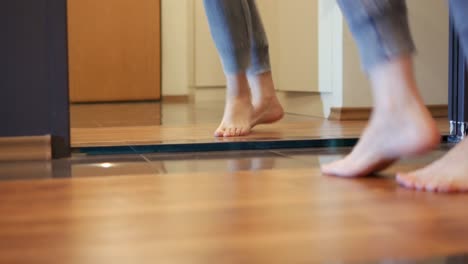 Woman feet dancing barefoot in front of mirror in apartment