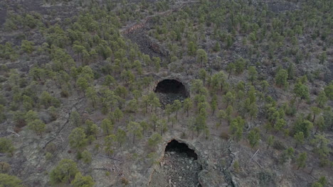 4k aerial panning down to el malpais lava tube natural bridges new mexico, 4k