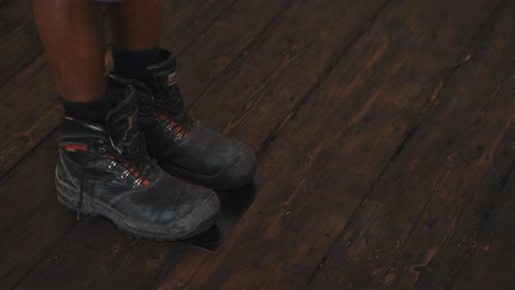 Black-tint-legs-in-black-work-boots,-close-up