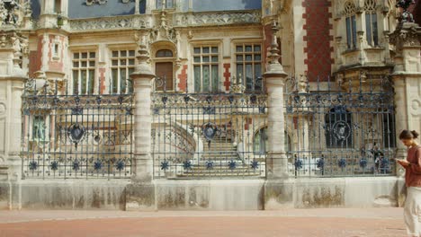 woman walking in front of a palace