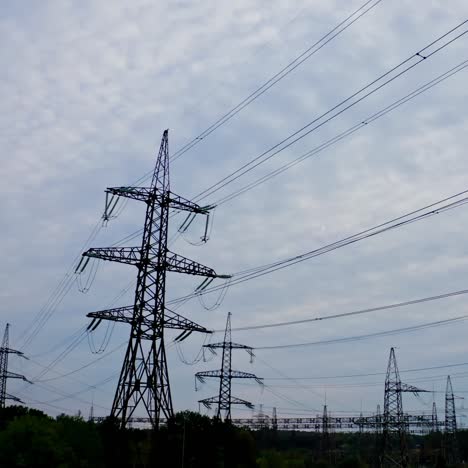 silhouette of electric towers in the evening. high-voltage electric lines under the beautiful sky. transmission lines. many electrical pylons in nature.