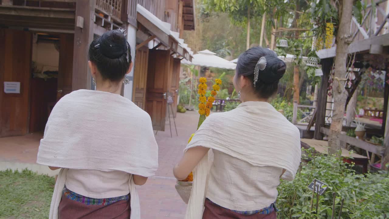 Back Of Two Girls In Thai Traditional Dress Walking, Slow Motion