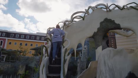 a woman is climbing up the stairs at the fairy tale house in da lat, vietnam