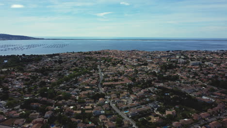 aerial view of a coastal town with fish farms