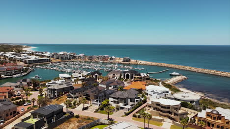 drone panorama of luxurious marina bay resort and townhouses with private harbor and yachts and boats anchored