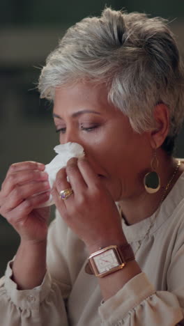 a woman with gray hair is crying and holding a tissue to her face.