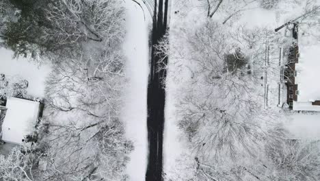 bird's eye track over a blacktop road after fresh snowfall