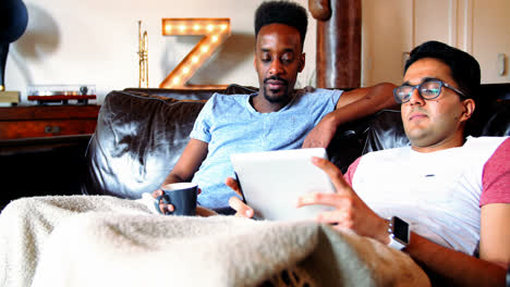 Gay-couple-relaxing-together-on-couch