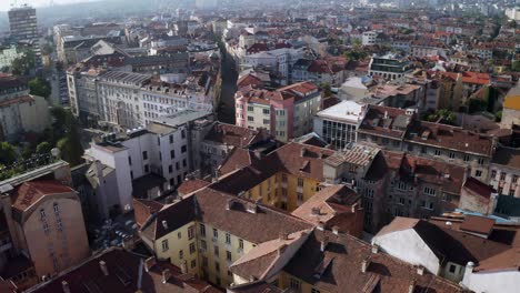 Scenic-flight-over-roofs-in-Sofia,-Bulgaria,-establishing-medieval-balkan-city