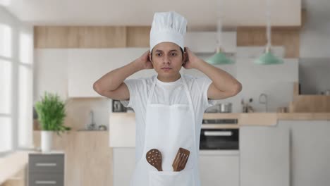 serious indian professional chef getting ready