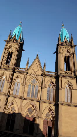 ornate architectural facade of a church with blue domes against a clear sky