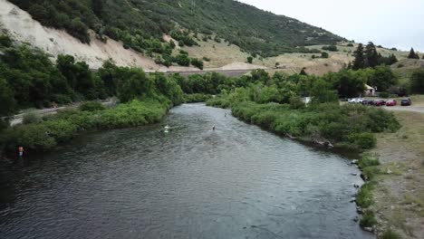 drone shot approaching a man fly fishing in the provo river in the mountains of utah-3