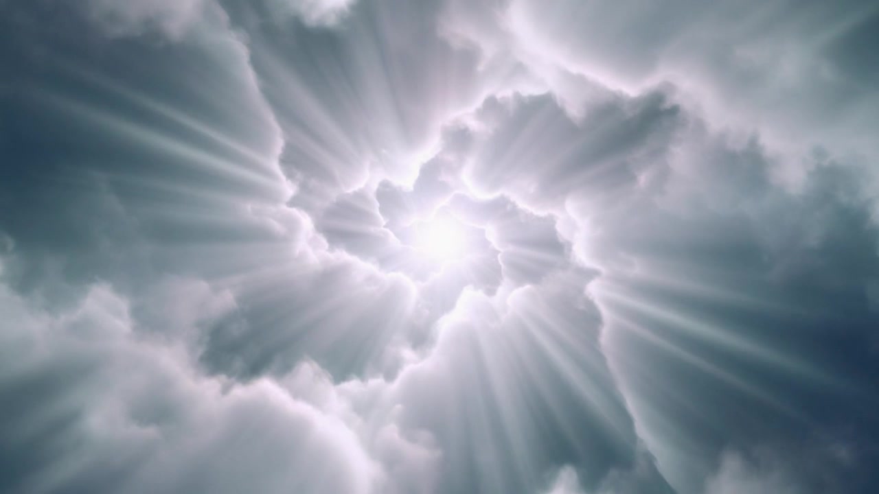 Bright Light Shining Through Swirling Clouds in the Sky