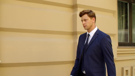 serious business man walking alone outdoors. thoughtful businessman