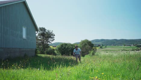 Person-Cutting-Fresh-Growing-Grass-In-Summer