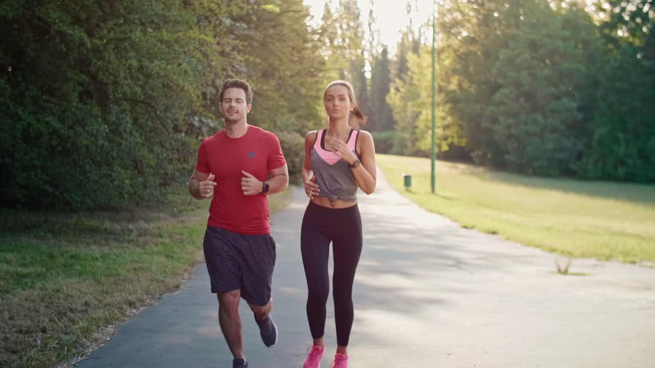 Young couple jogging during sunny afternoon, Katowice, Poland