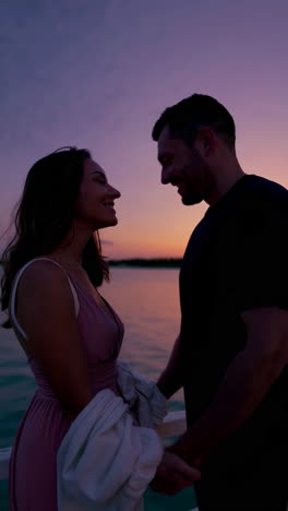 couple enjoying sunset on pier