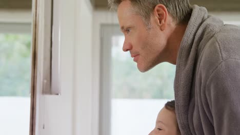 father brushing off daughters teeth 4k