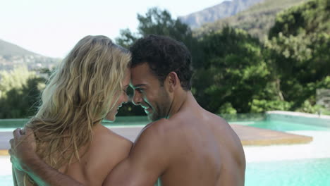 cute couple embracing on the poolside